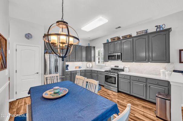 Chandelier, Dining room, Interior, Kitchen, Pendant Lights, Stainless Steel Appliances, Wood Texture Flooring