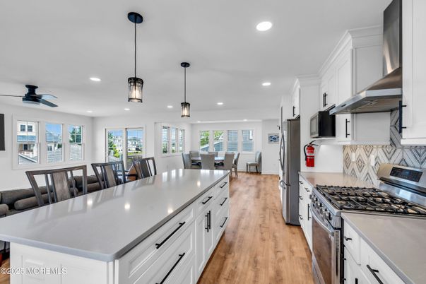 Dining room, Interior, Kitchen, Pendant Lights, Recessed Lighting, Stainless Steel Appliances, Wood Texture Flooring