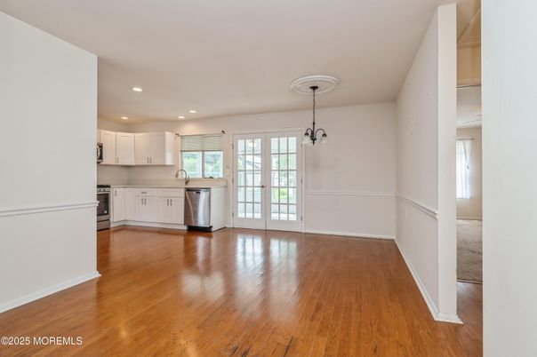 Empty room, Interior, Kitchen, Pendant Lights, Recessed Lighting, Stainless Steel Appliances, Wood Texture Flooring