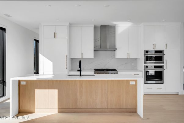 Interior, Kitchen, Marble Walls, Recessed Lighting, Stainless Steel Appliances, Wood Texture Flooring