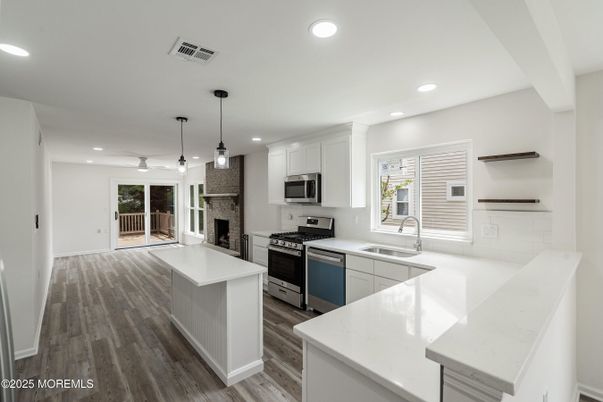 Fireplace, Interior, Kitchen, Pendant Lights, Recessed Lighting, Stainless Steel Appliances, Wood Texture Flooring