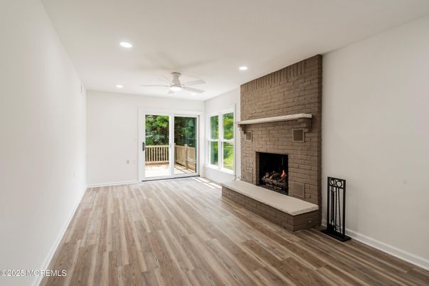 Empty room, Fireplace, Interior, Recessed Lighting, Stone Walls, Wood Texture Flooring