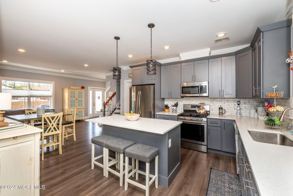 Dining room, Interior, Kitchen, Pendant Lights, Recessed Lighting, Stainless Steel Appliances, Wood Texture Flooring