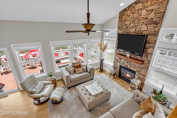 Fireplace, Interior, Living room, Recessed Lighting, Stone Walls, Wood Texture Flooring