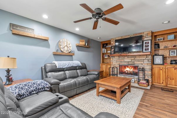 Fireplace, Interior, Living room, Recessed Lighting, Stone Walls, Wood Texture Flooring