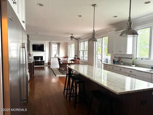 Dining room, Fireplace, Interior, Kitchen, Pendant Lights, Recessed Lighting, Stainless Steel Appliances, Wood Texture Flooring