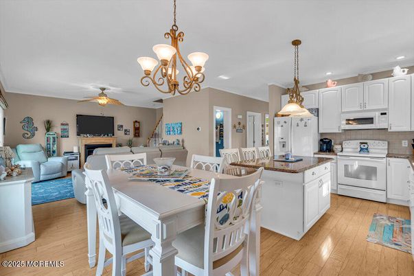 Chandelier, Dining room, Fireplace, Interior, Kitchen, Living room, Pendant Lights, Recessed Lighting, Wood Texture Flooring
