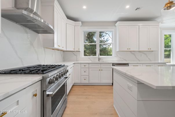 Interior, Kitchen, Marble Walls, Recessed Lighting, Stainless Steel Appliances, Wood Texture Flooring