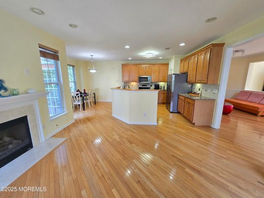 Chandelier, Dining room, Fireplace, Interior, Kitchen, Pendant Lights, Recessed Lighting, Stainless Steel Appliances, Wood Texture Flooring