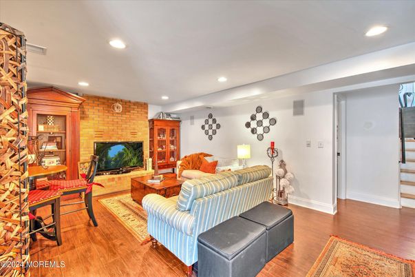 Fireplace, Interior, Living room, Recessed Lighting, Stone Walls, Wood Texture Flooring