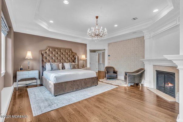 Bedroom, Chandelier, Fireplace, Interior, Recessed Lighting, Wood Texture Flooring