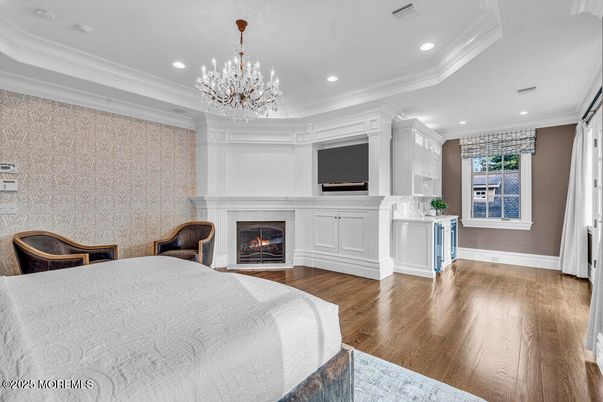 Bedroom, Chandelier, Fireplace, Interior, Recessed Lighting, Wood Texture Flooring
