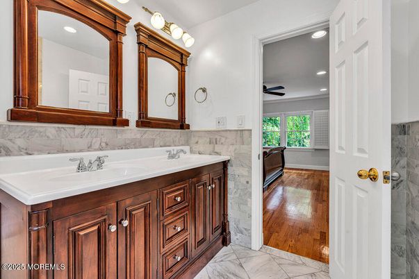 Bathroom, Dual Sink Vanities, Interior, Marble, Marble Walls, Recessed Lighting, Wood Texture Flooring
