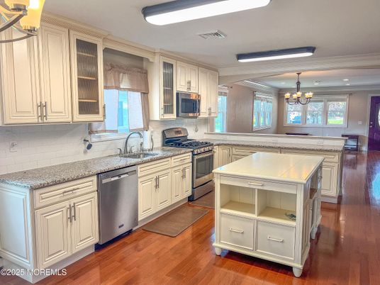 Chandelier, Dining room, Interior, Kitchen, Recessed Lighting, Stainless Steel Appliances, Wood Texture Flooring