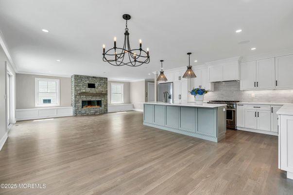 Chandelier, Fireplace, Interior, Kitchen, Pendant Lights, Recessed Lighting, Stainless Steel Appliances, Wood Texture Flooring