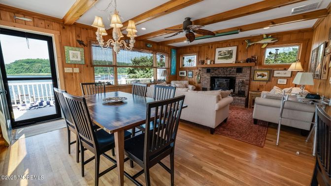 Chandelier, Dining room, Fireplace, Interior, Living room, Recessed Lighting, Stone Walls, Wooden Beams, Wood Texture Flooring, Wooden Walls