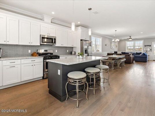 Chandelier, Dining room, Interior, Kitchen, Living room, Pendant Lights, Recessed Lighting, Stainless Steel Appliances, Wood Texture Flooring