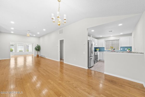 Chandelier, Empty room, Interior, Kitchen, Recessed Lighting, Stainless Steel Appliances, Wood Texture Flooring