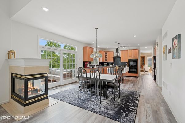 Dining room, Fireplace, Interior, Kitchen, Pendant Lights, Recessed Lighting, Stainless Steel Appliances, Wood Texture Flooring
