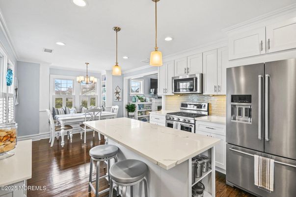 Chandelier, Dining room, Interior, Kitchen, Pendant Lights, Recessed Lighting, Stainless Steel Appliances, Wood Texture Flooring