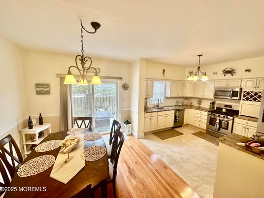 Chandelier, Dining room, Interior, Kitchen, Pendant Lights, Stainless Steel Appliances, Wood Texture Flooring