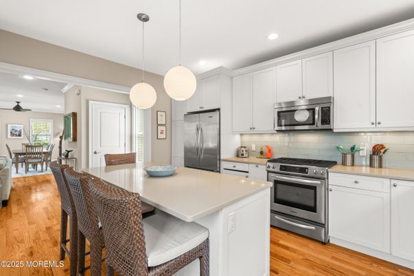 Dining room, Interior, Kitchen, Pendant Lights, Recessed Lighting, Stainless Steel Appliances, Wood Texture Flooring