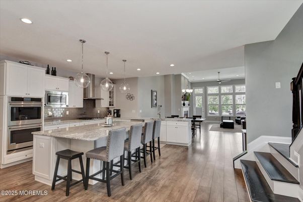 Dining room, Interior, Kitchen, Pendant Lights, Recessed Lighting, Stainless Steel Appliances, Wood Texture Flooring