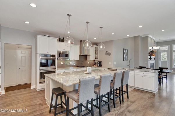 Chandelier, Dining room, Interior, Kitchen, Pendant Lights, Recessed Lighting, Stainless Steel Appliances, Wood Texture Flooring