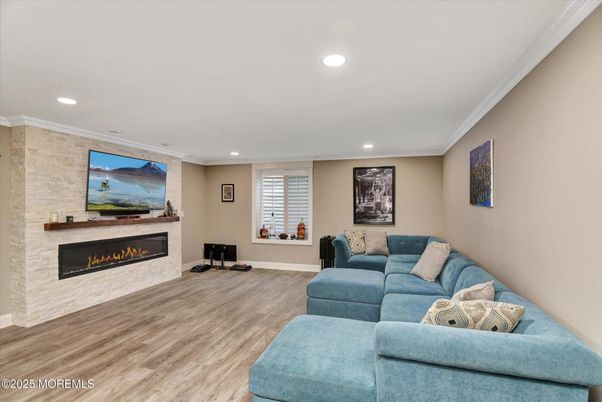 Fireplace, Interior, Living room, Recessed Lighting, Stone Walls, Wood Texture Flooring