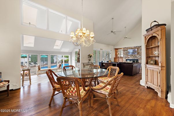 Chandelier, Dining room, Fireplace, Interior, Living room, Stone Walls, Wood Texture Flooring