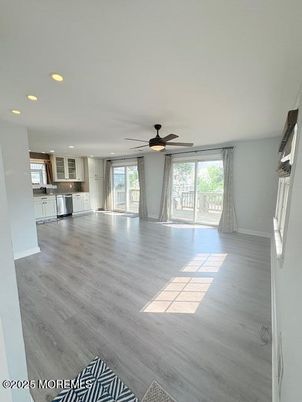 Empty room, Interior, Kitchen, Recessed Lighting, Stainless Steel Appliances, Wood Texture Flooring