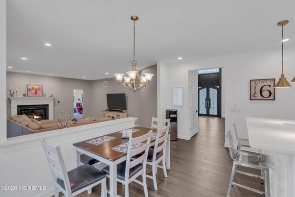 Chandelier, Dining room, Fireplace, Interior, Living room, Pendant Lights, Recessed Lighting, Wood Texture Flooring