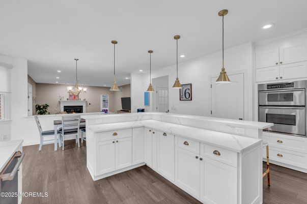 Dining room, Fireplace, Interior, Kitchen, Pendant Lights, Recessed Lighting, Stainless Steel Appliances, Wood Texture Flooring