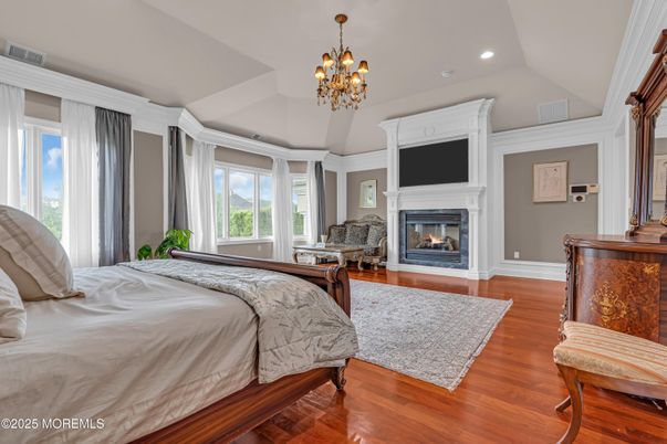 Bedroom, Chandelier, Fireplace, Interior, Recessed Lighting, Wood Texture Flooring