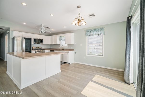 Chandelier, Interior, Kitchen, Recessed Lighting, Stainless Steel Appliances, Wood Texture Flooring