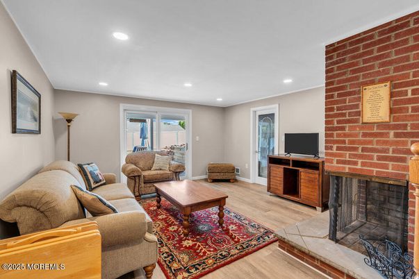 Fireplace, Interior, Living room, Recessed Lighting, Stone Walls, Wood Texture Flooring