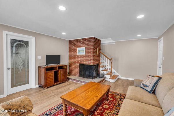Fireplace, Interior, Living room, Recessed Lighting, Stone Walls, Wood Texture Flooring