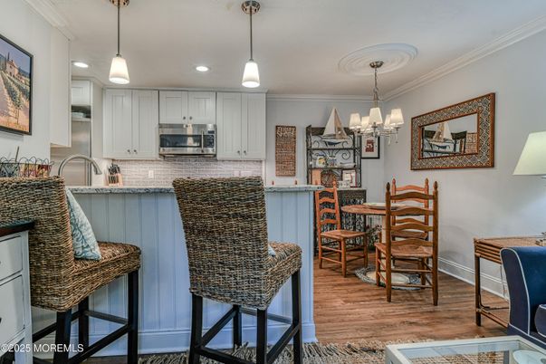 Chandelier, Dining room, Interior, Kitchen, Pendant Lights, Recessed Lighting, Stainless Steel Appliances, Wood Texture Flooring