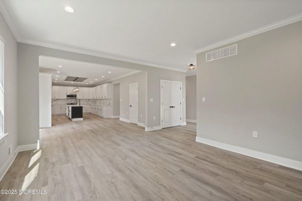 Empty room, Interior, Kitchen, Recessed Lighting, Stainless Steel Appliances, Wood Texture Flooring