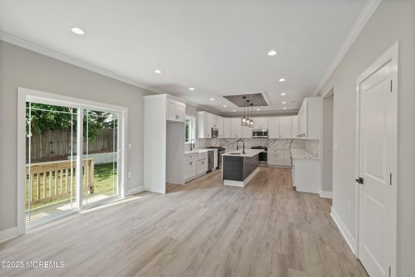 Interior, Kitchen, Marble Walls, Pendant Lights, Recessed Lighting, Stainless Steel Appliances, Wood Texture Flooring