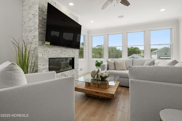 Fireplace, Interior, Living room, Recessed Lighting, Stone Walls, Wood Texture Flooring