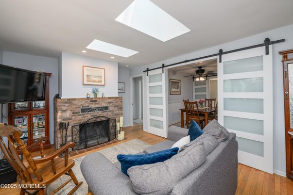 Dining room, Fireplace, Interior, Living room, Recessed Lighting, Wood Texture Flooring