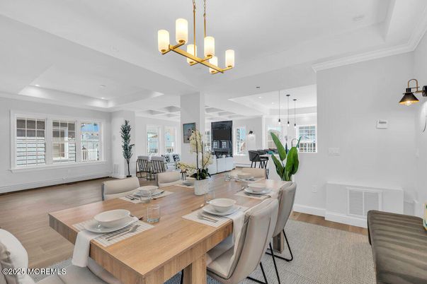 Chandelier, Dining room, Fireplace, Interior, Living room, Pendant Lights, Recessed Lighting, Wood Texture Flooring