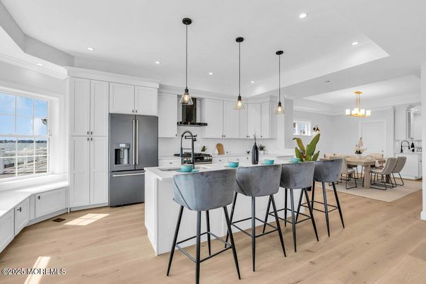 Chandelier, Dining room, Interior, Kitchen, Pendant Lights, Recessed Lighting, Stainless Steel Appliances, Wood Texture Flooring