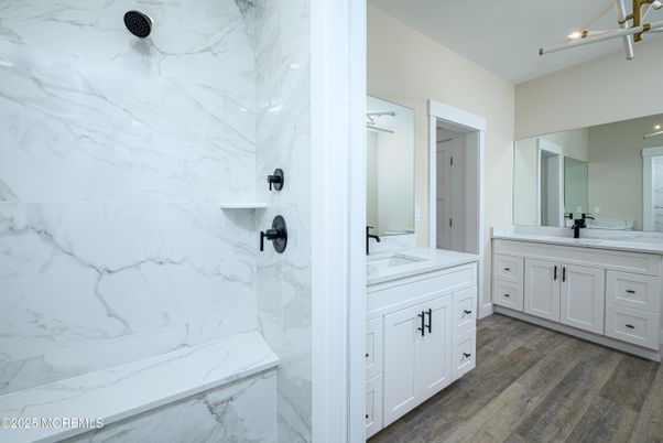 Bathroom, Dual Sink Vanities, Interior, Marble Walls, Recessed Lighting, Wood Texture Flooring