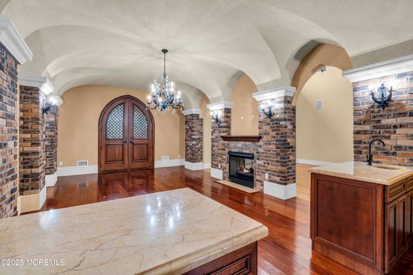 Chandelier, Fireplace, Interior, Stone Walls, Wood Texture Flooring