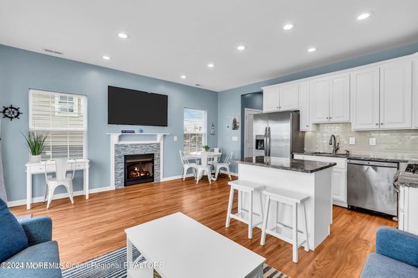 Dining room, Fireplace, Interior, Kitchen, Recessed Lighting, Stainless Steel Appliances, Wood Texture Flooring