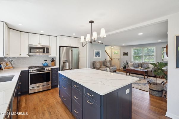 Chandelier, Dining room, Interior, Kitchen, Living room, Pendant Lights, Recessed Lighting, Stainless Steel Appliances, Wood Texture Flooring