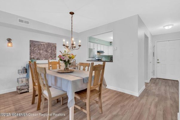 Chandelier, Dining room, Interior, Kitchen, Pendant Lights, Stainless Steel Appliances, Wood Texture Flooring