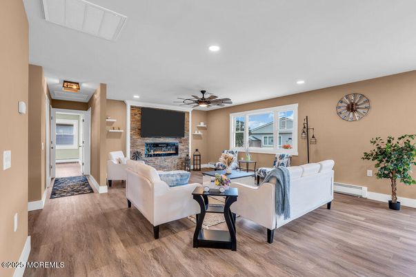 Fireplace, Interior, Living room, Recessed Lighting, Stone Walls, Wood Texture Flooring